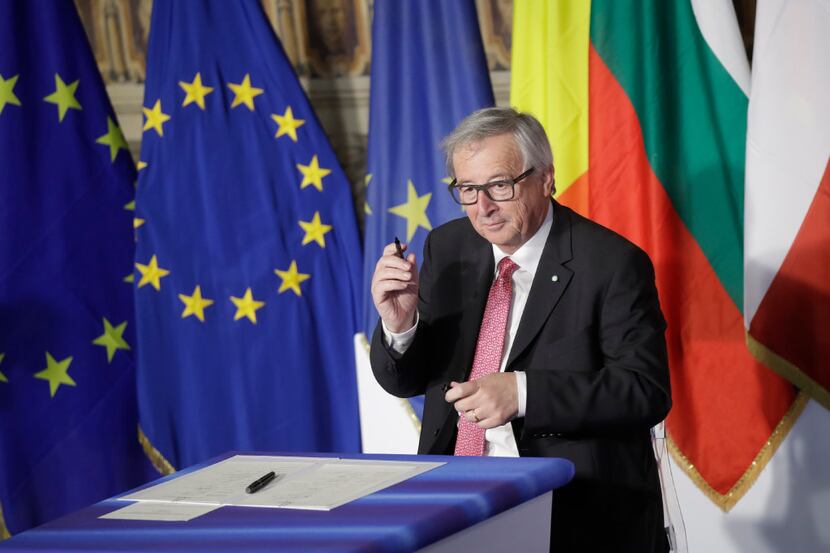 European Commission President Jean-Claude Juncker signs a declaration during an EU summit...