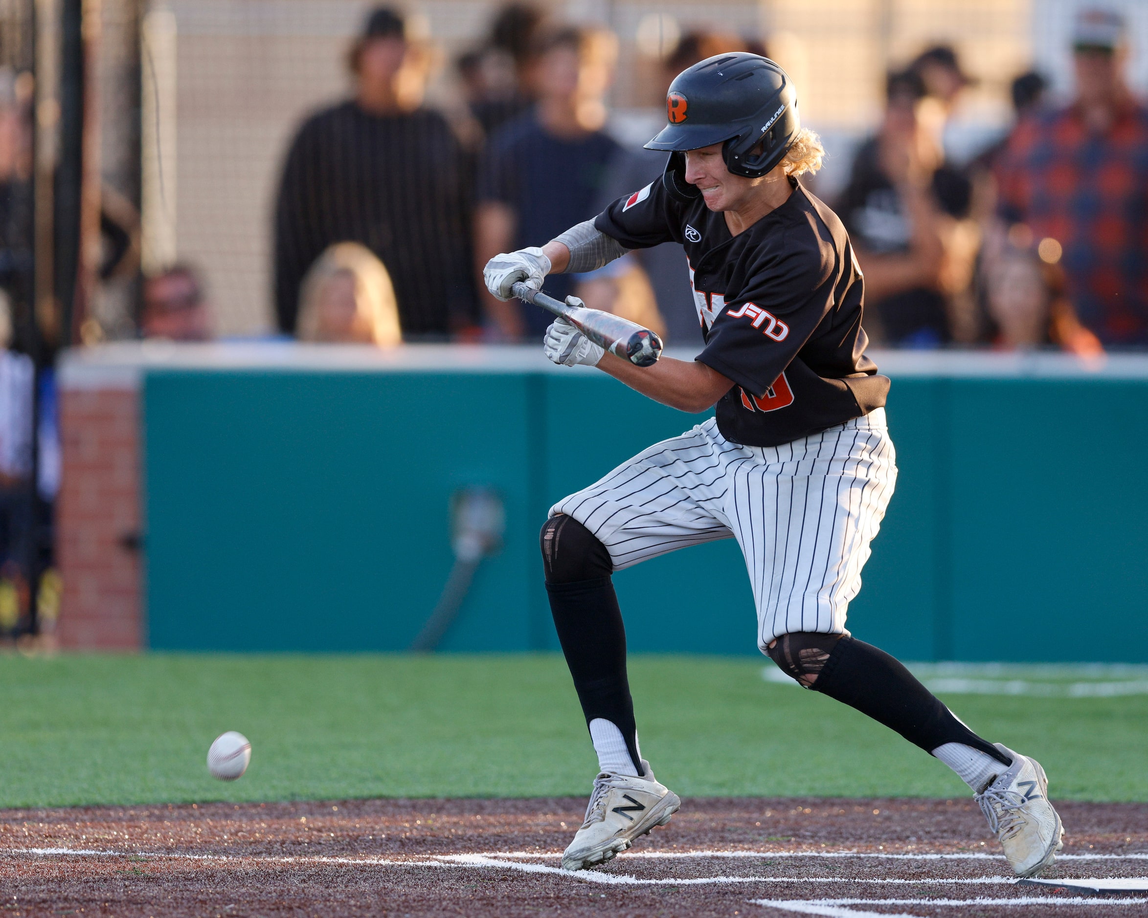 Rockwall third baseman Pearson Riebock (10) attempts a bunt against Waxahachie during a...