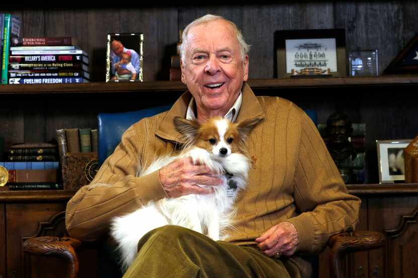 T. Boone Pickens, chairman and CEO of BP Capital, poses in his office with his dog, Murdock....