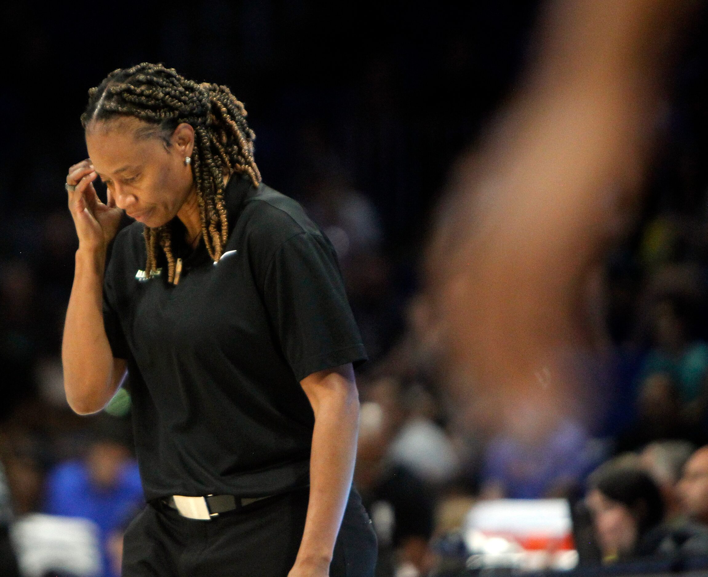 Dallas Wings head coach Vickie Johnson contemplates her message to players after calling a...