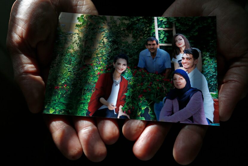 Faris Saleh shows a family photo at his home in Plano, Texas, Thursday, Feb. 1, 2018. (Jae...