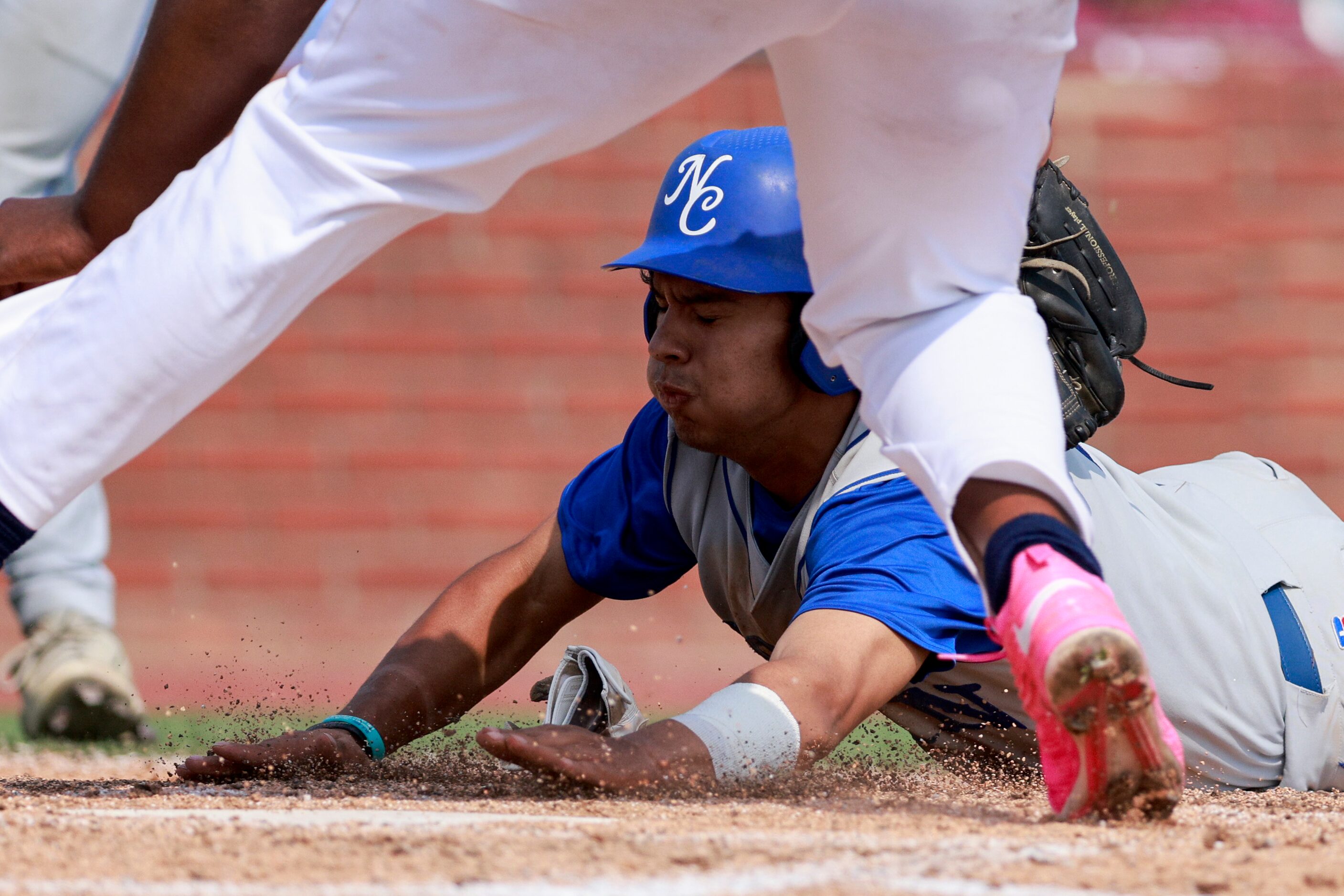 Plano Prestonwood pitcher Trent Shaw (23) tags Fort Worth Nolan outfielder Santiago Perez...