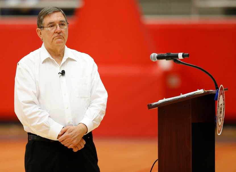 Congressman Michael Burgess listens to a question during a town hall meeting at Marcus High...