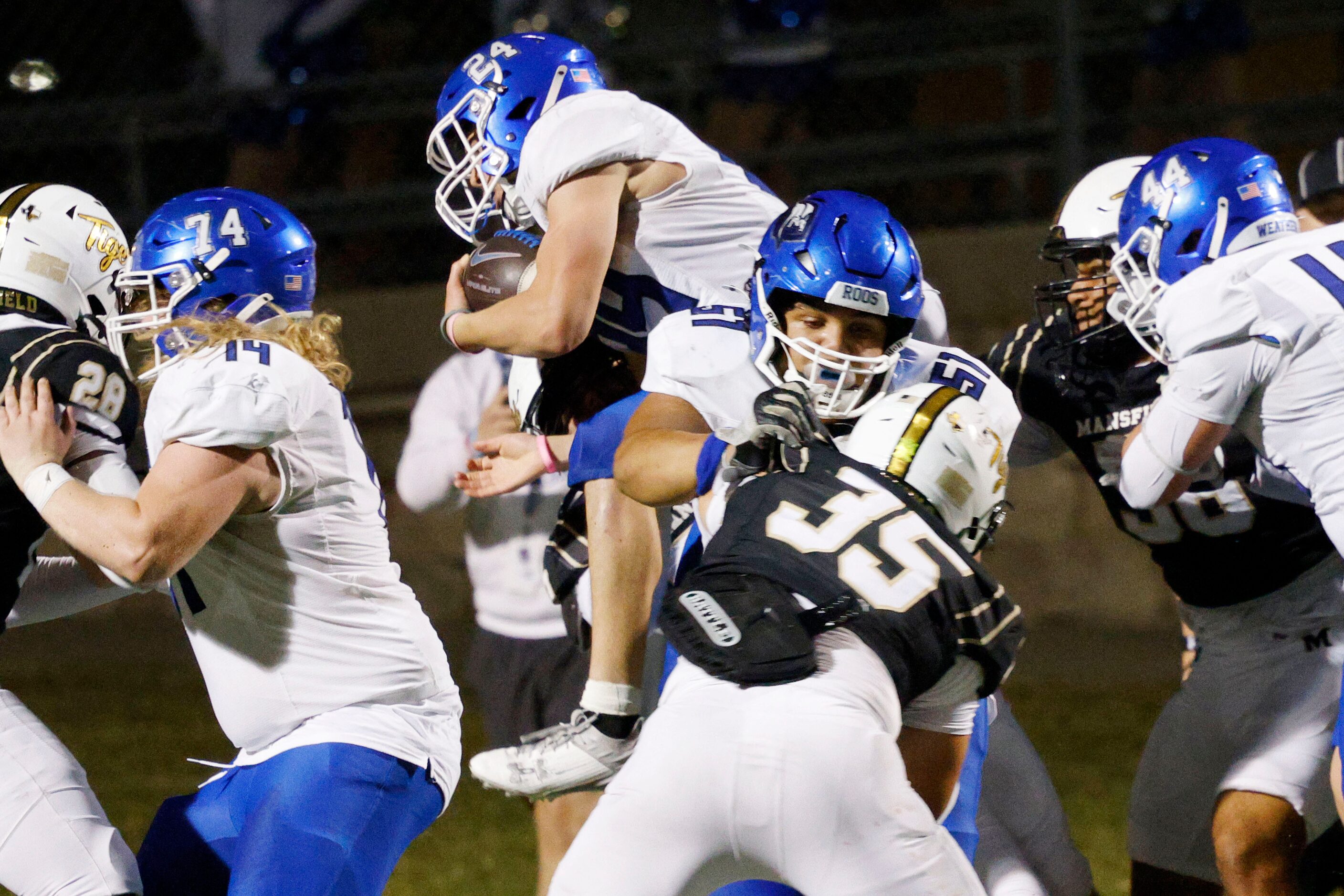 Weatherford's Xavier Craven (24), top, scores a touchdown over Mansfield in the first half...