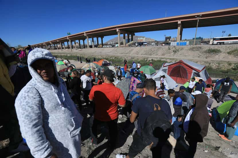 Dozens of migrants expelled from the Unites States set up a camp along the Rio Grande in...