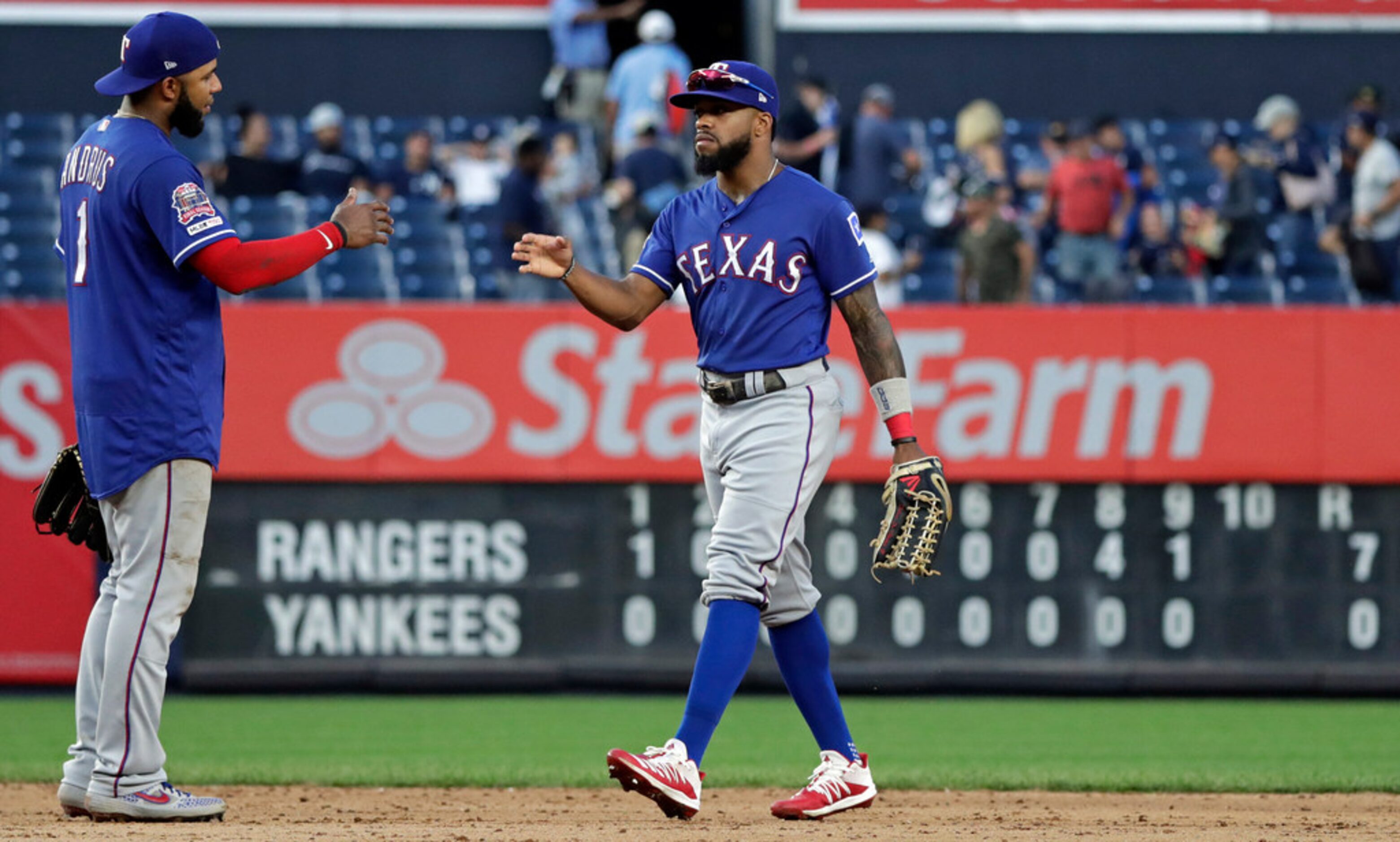 Texas Rangers center fielder Delino DeShields celebrates with shortstop Elvis Andrus (1)...