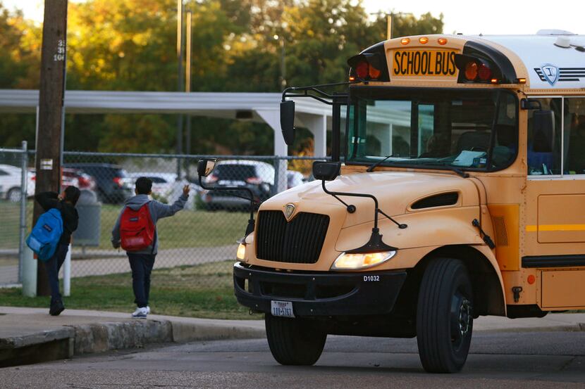 Buses drop students off at W.E. Greiner Exploratory Arts Academy in Dallas on Oct. 25, 2017....
