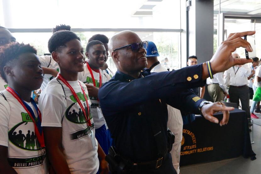 Dallas Police Chief David Brown takes a selfie with a group of kids during "Let's Talk," a...