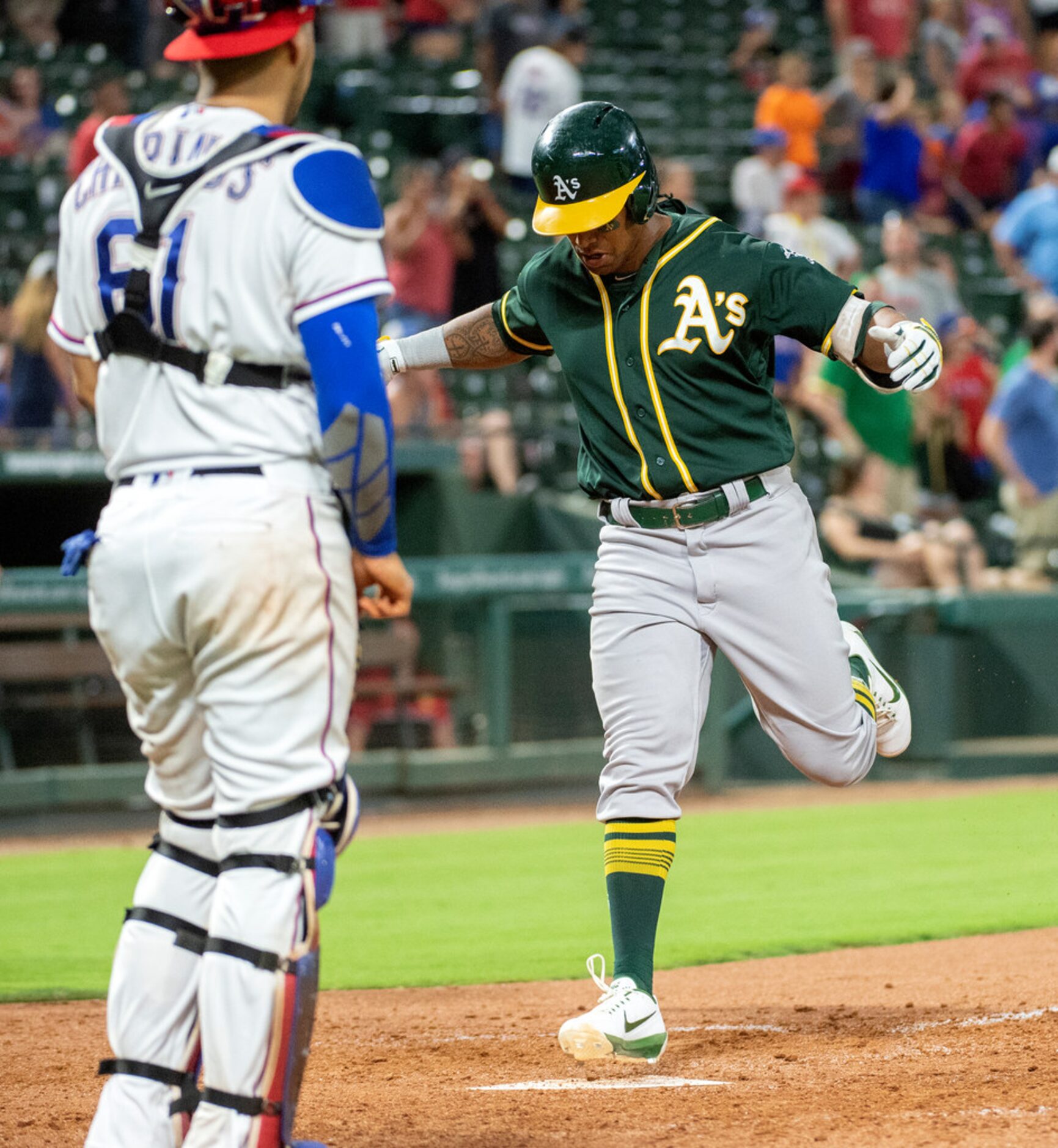 Oakland Athletics' Khris Davis crosses the plate on a go-ahead two-run home run off Texas...