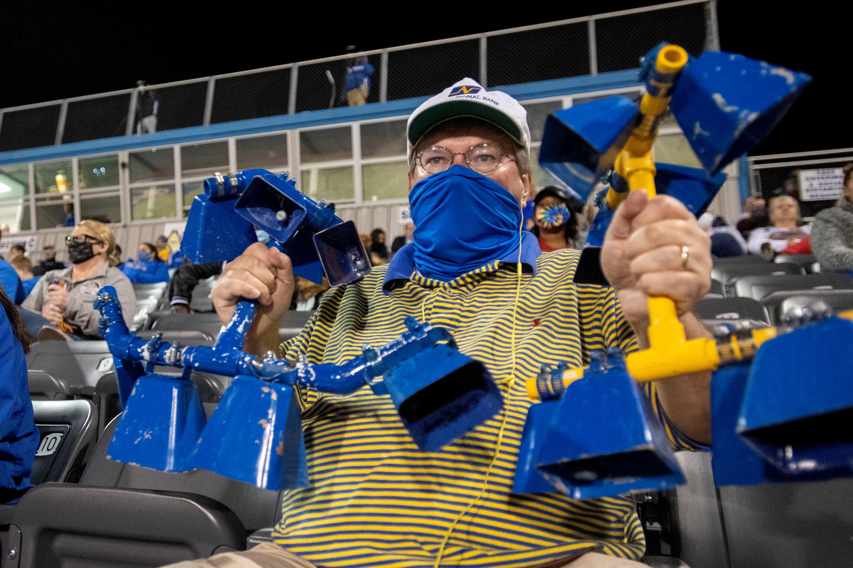 Sunnyvale fan and school board member Michael Threet uses a homemade cowbell contraption to...