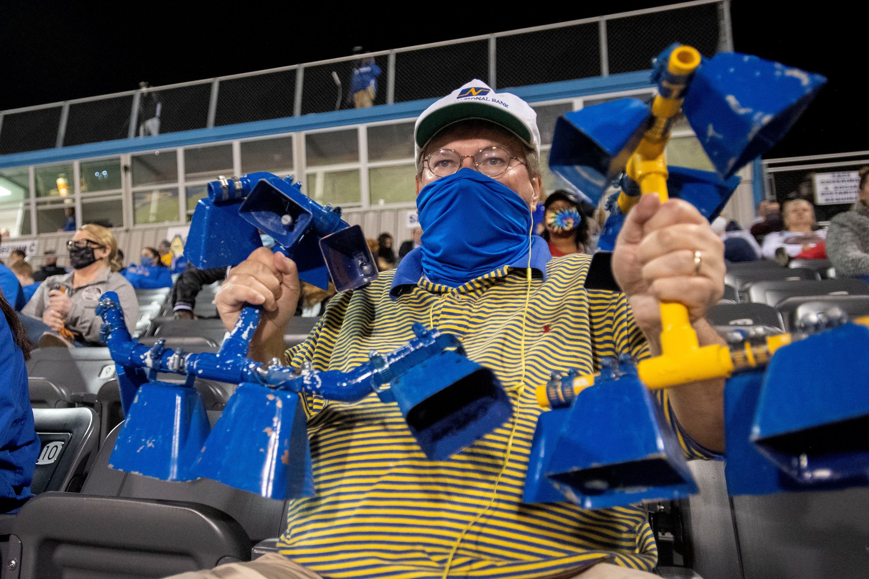 Sunnyvale fan and school board member Michael Threet uses a homemade cowbell contraption to...