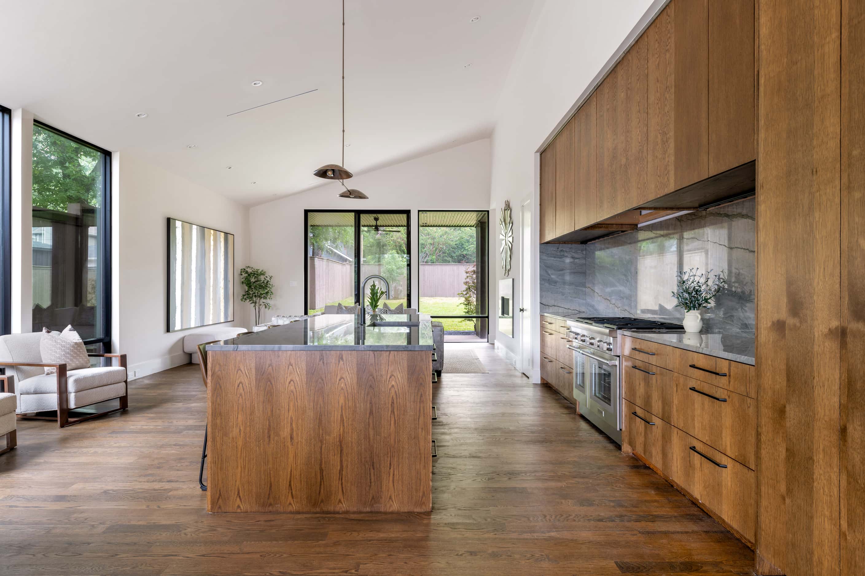 Kitchen with brown wood countertops, wood floors and open-concept floor plan