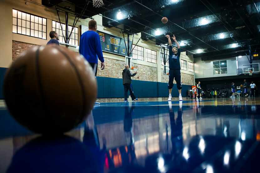 Dallas Mavericks forward Dirk Nowitzki shoots free throws as he warms up on the team's...