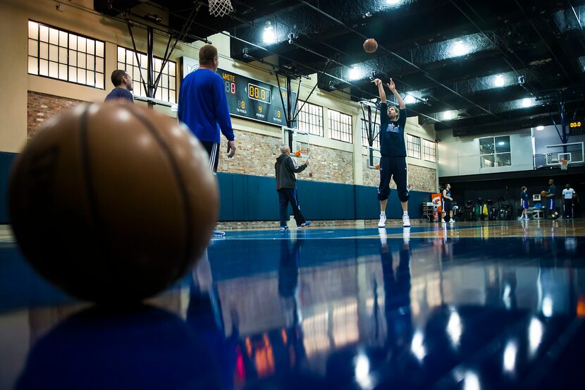 Dallas Mavericks forward Dirk Nowitzki shoots free throws as he warms up on the team's...