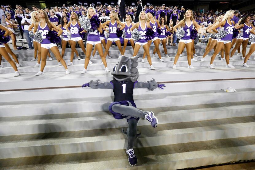 TCU Horned Frogs mascot Super Frog relaxes pn the steps before the Showgirls dance team...