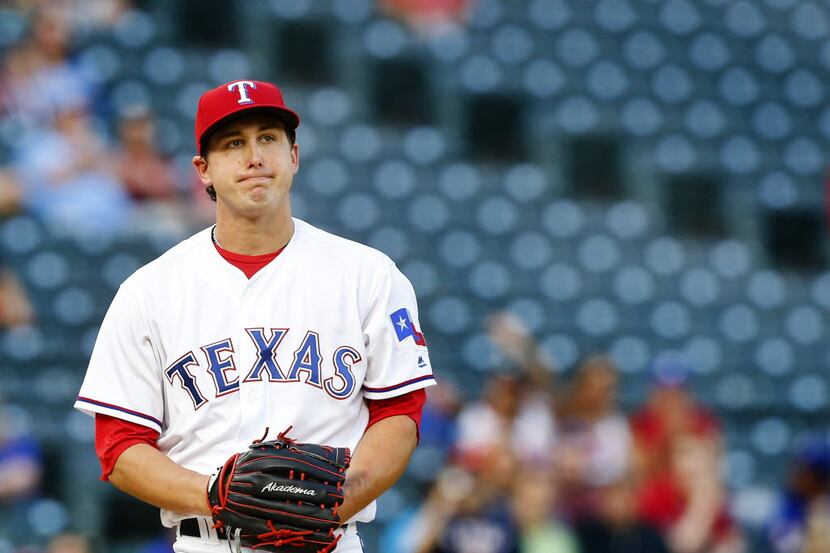 Texas Rangers starting pitcher Derek Holland (45) reacts after a missed strike in the first...