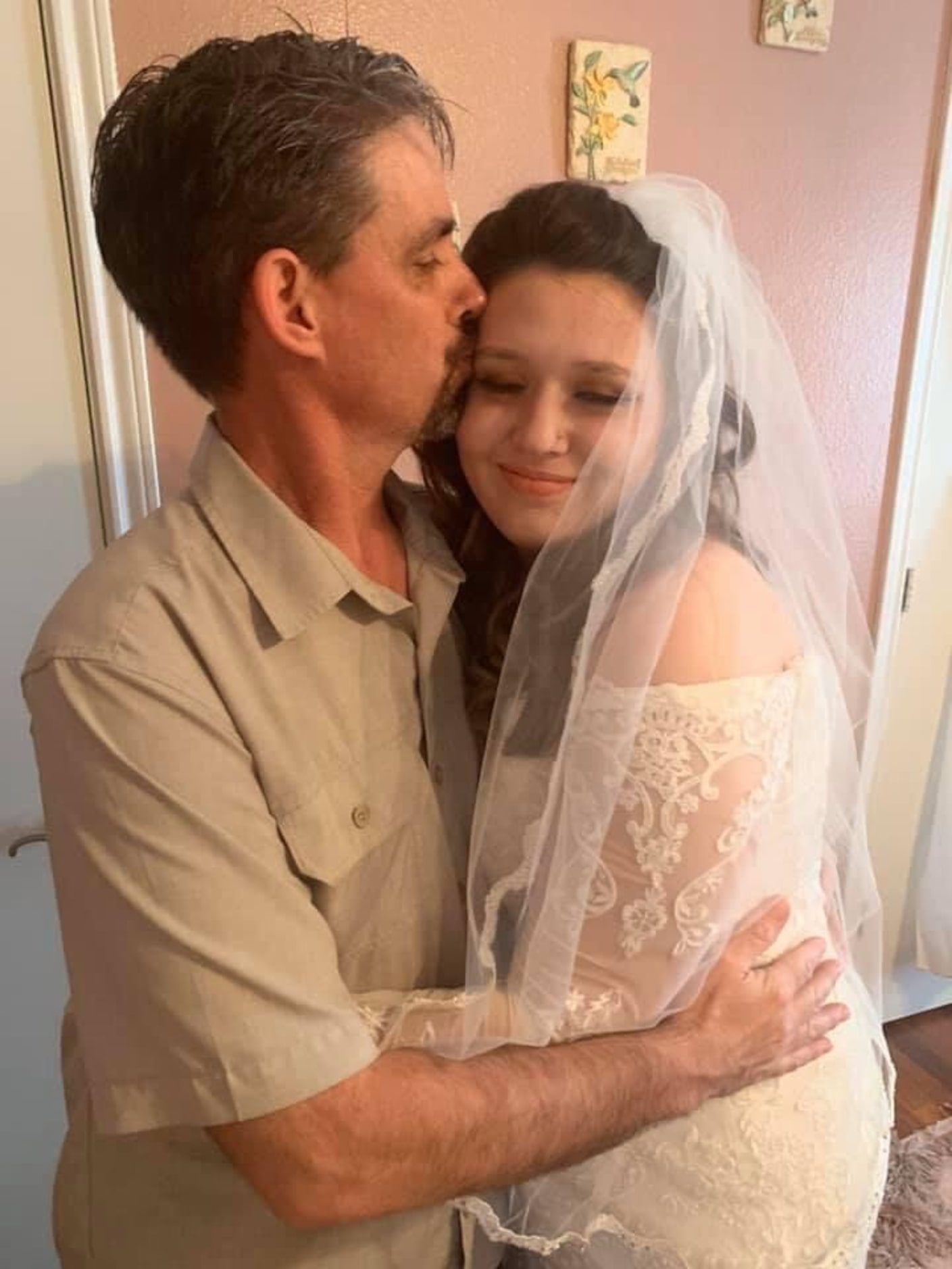 Michael Wells shown in an undated photo with his daughter, Micah, on her wedding day.