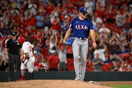 Texas Rangers starting pitcher Cody Bradford, right, waits after giving up a grand slam to...