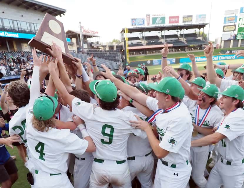 Southlake Carroll players celebrate after defeating San Antonio Reagan in the UIL baseball...