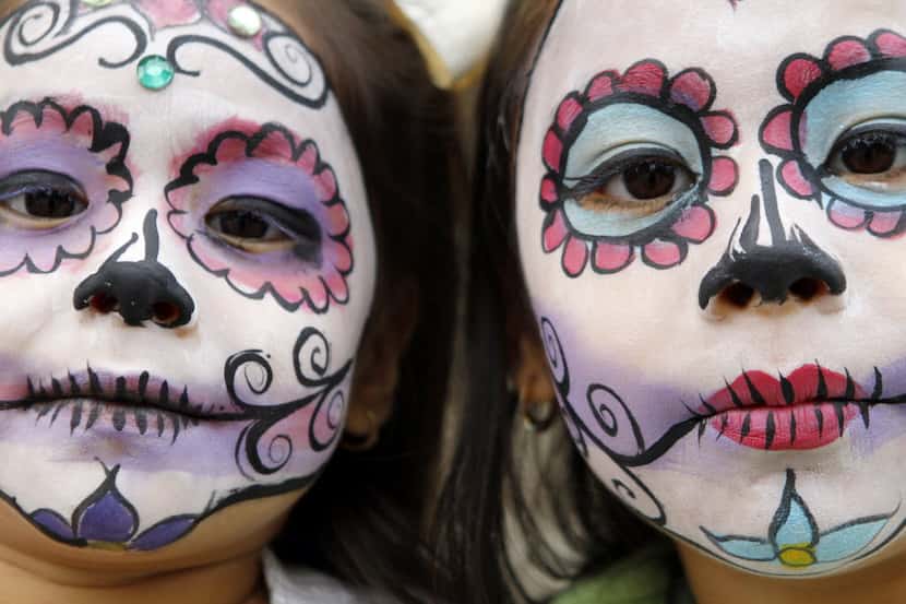 Sisters Cristal Ortega, 4 (left), and her sister Kenya Ortega, 7, show off their day of the...