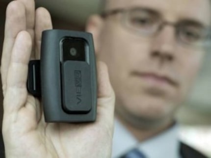  Dallas police Sgt. Derek McCarter shows a camera sold by VieVU that is made to be worn on...