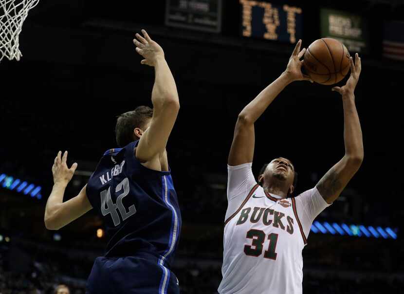 Milwaukee Bucks' John Henson rebounds over Dallas Mavericks' Maximilian Kleber during the...
