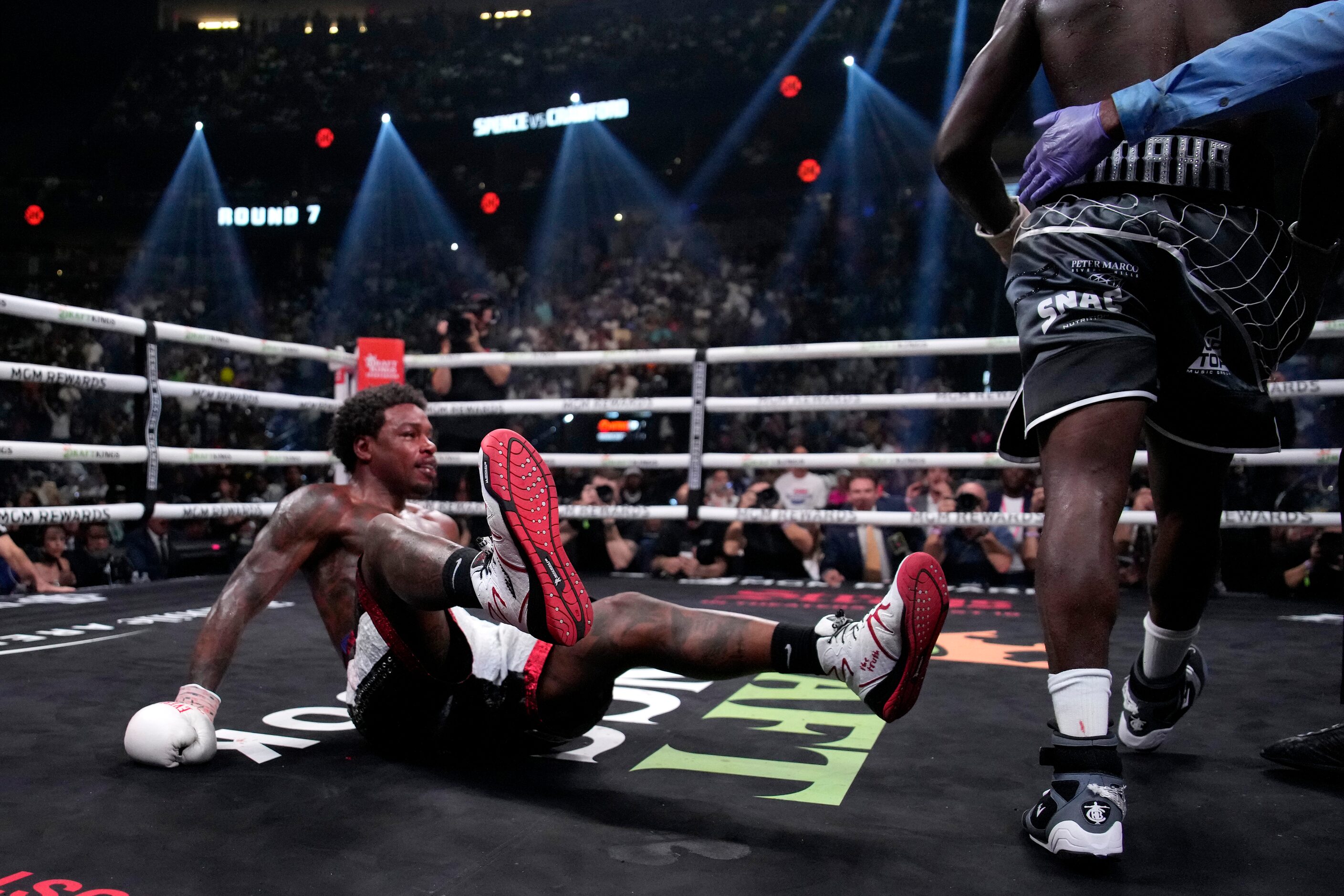 Errol Spence Jr., right, is knocked down by Terence Crawford, right, during their...