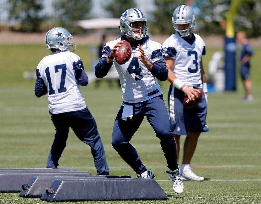 Dallas Cowboys quarterbacks Dak Prescott (4), Kellen Moore (17) and Austin Appleby (3) run...