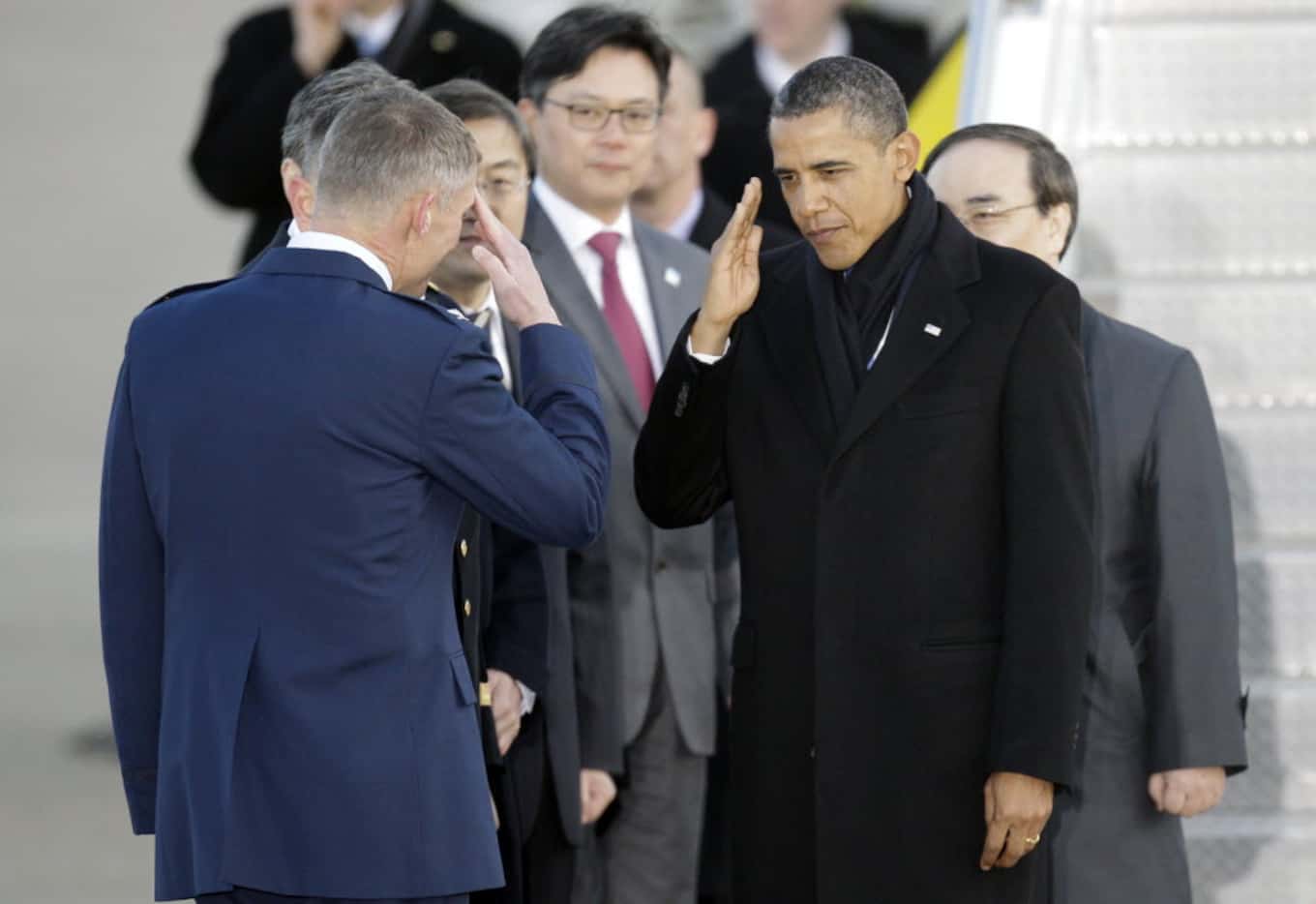 President Barack Obama salutes upon arrival at Osan Air Base to attend the Nuclear Security...