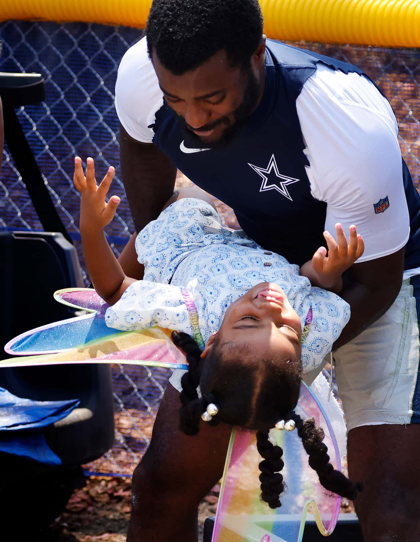 Dallas Cowboys cornerback Jourdan Lewis hugs his daughter Riley mom Arille mom at training...