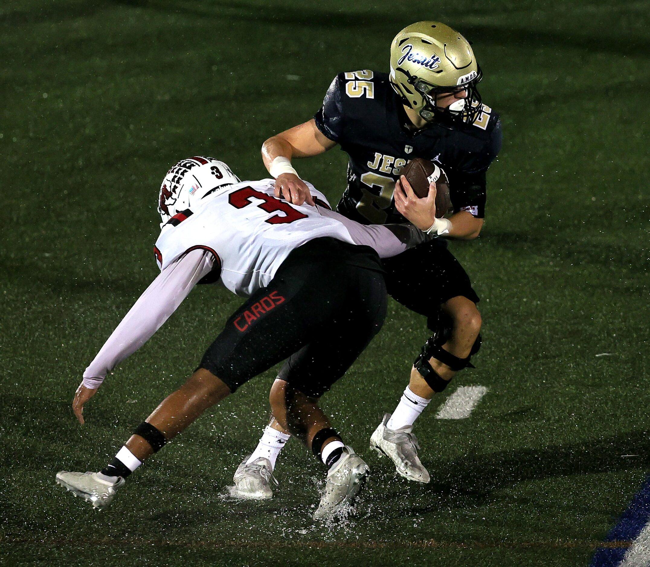 Jesuit running back Cameron Martin (25) tries to elude MacArthur safety Ke'shawn Ford (3)...