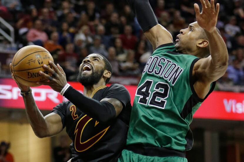 FILE - In this Dec. 29, 2016, file photo, Cleveland Cavaliers' Kyrie Irving, left, drives to...
