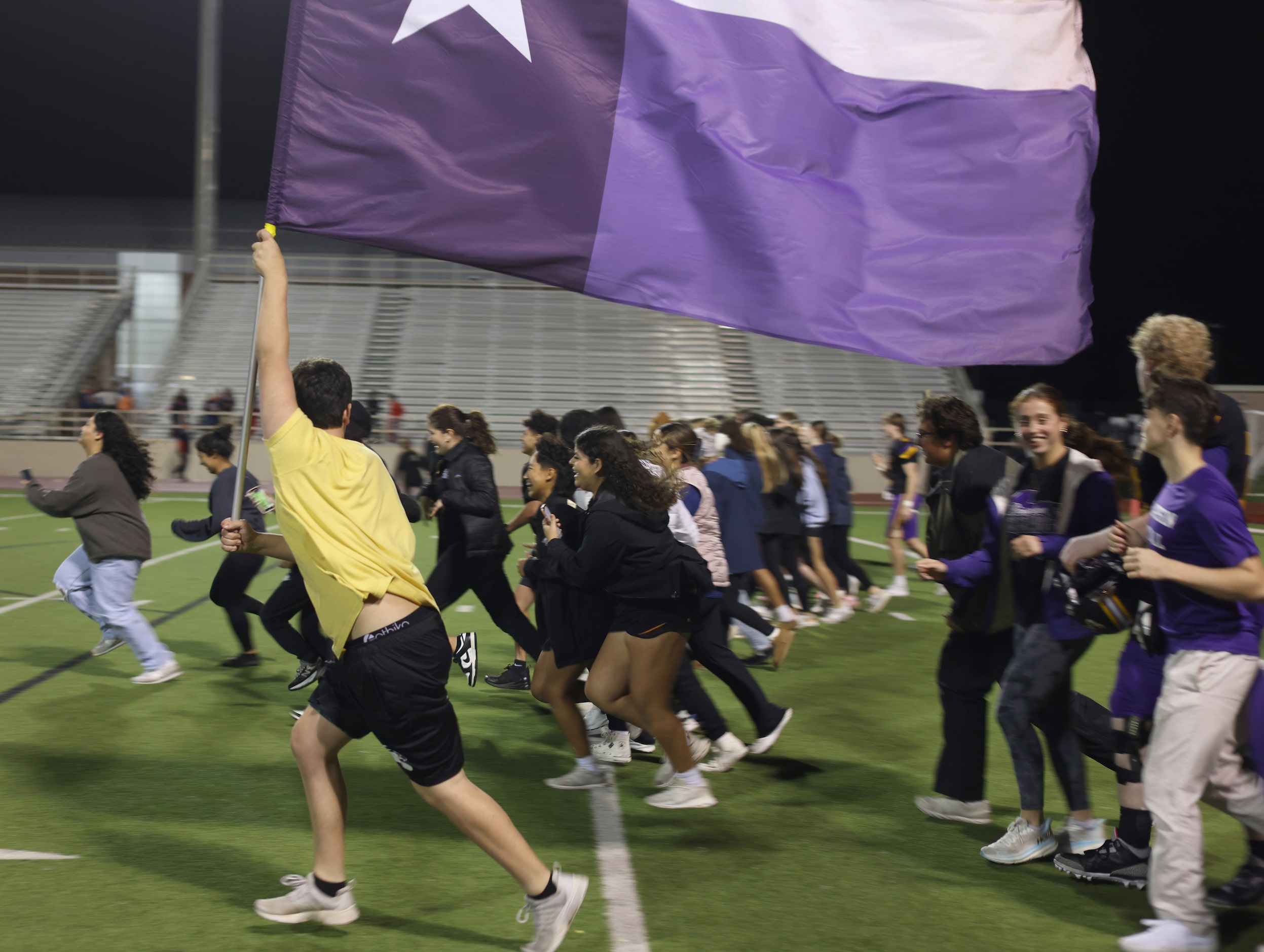 Richardson fans run the length of the field in celebration of the team's 37-7 victory over...