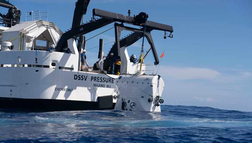 The Five Deeps Expedition lowers the Limiting Factor submersible into the ocean off the...