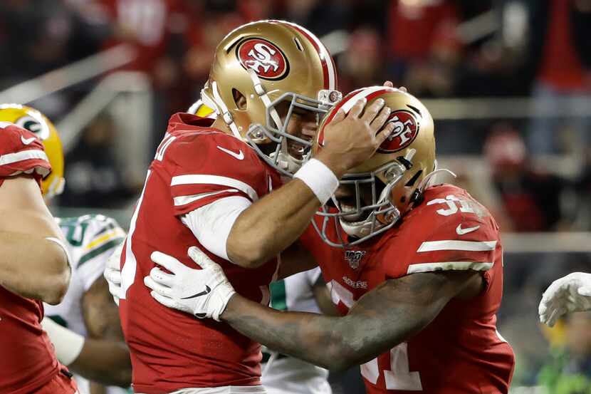 San Francisco 49ers running back Raheem Mostert, right, celebrates his touchdown with...
