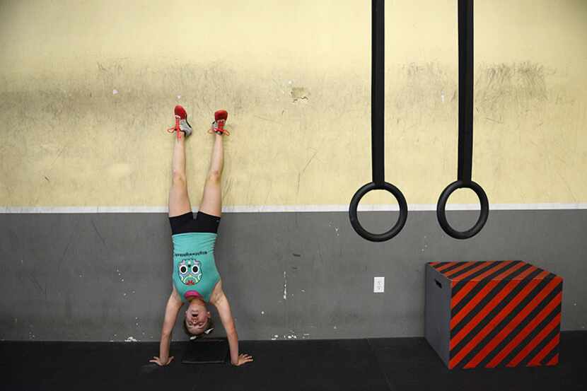  Brooklin Smith, 13, trains for weightlifting at CrossFit Rockwall on June 2, 2014. Brooklin...