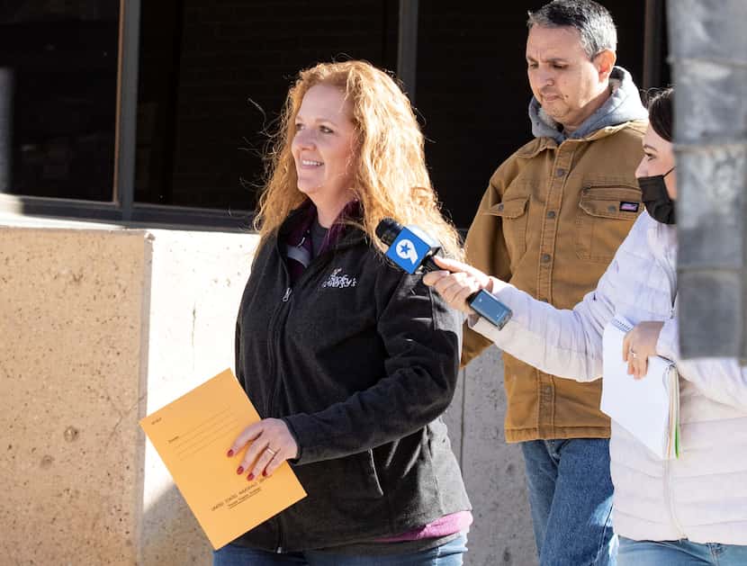 Jenny Cudd (left) Eliel Rosa (behind, in tan coat) left the federal courthouse in Midland...