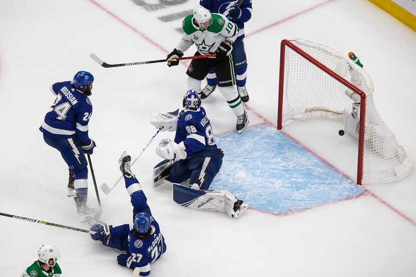 Corey Perry (10) of the Dallas Stars looks on as the puck sails past goaltender Andrei...