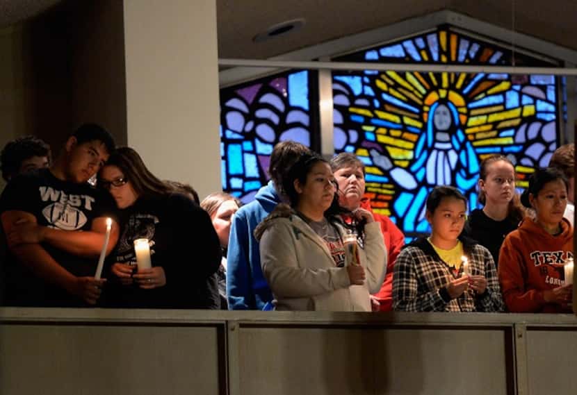 West residents at a candlelight vigil Thursday in St. Mary's Church of the Assumption.