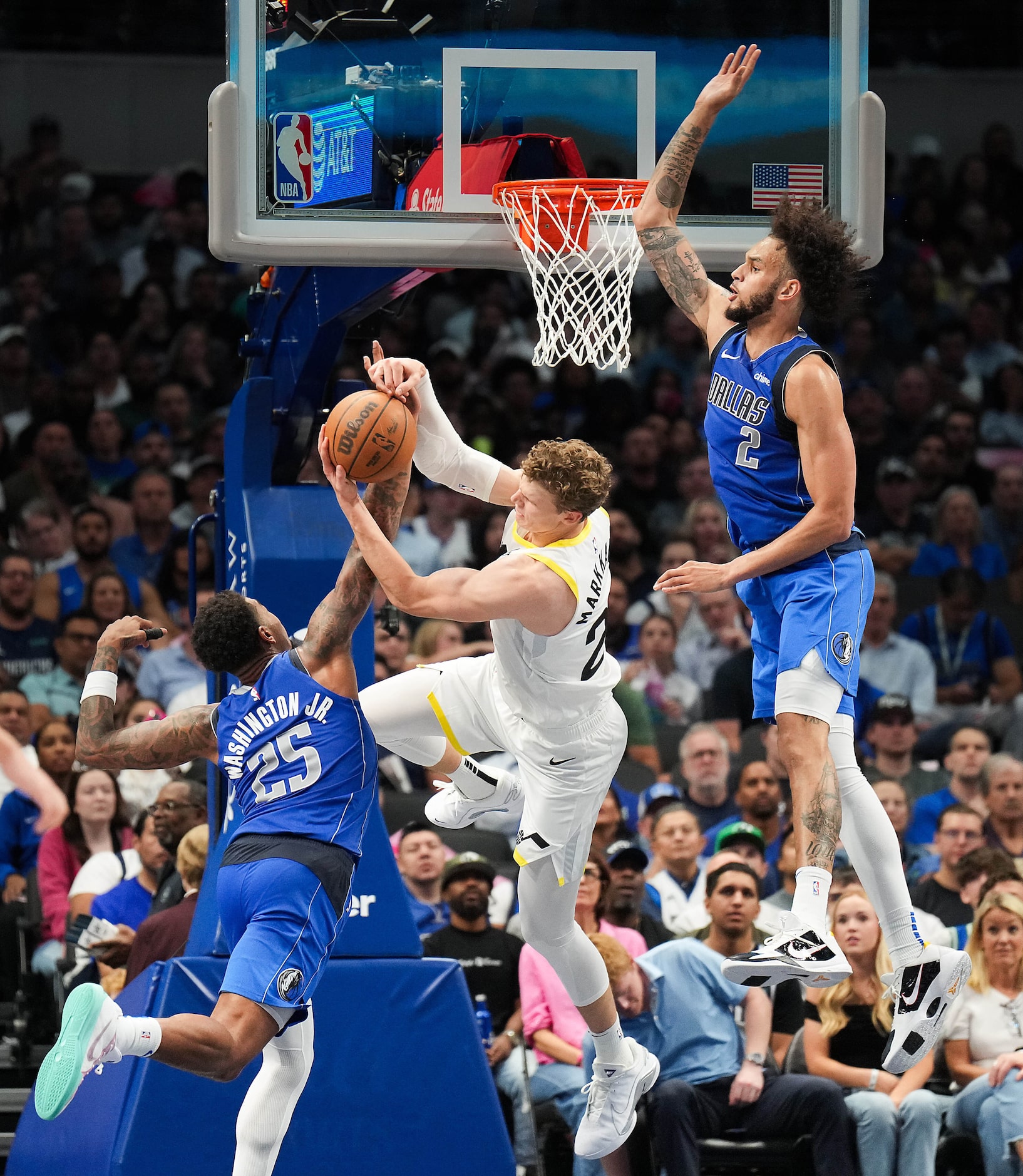 Dallas Mavericks forward P.J. Washington (25) and center Dereck Lively II (2) defend a drive...