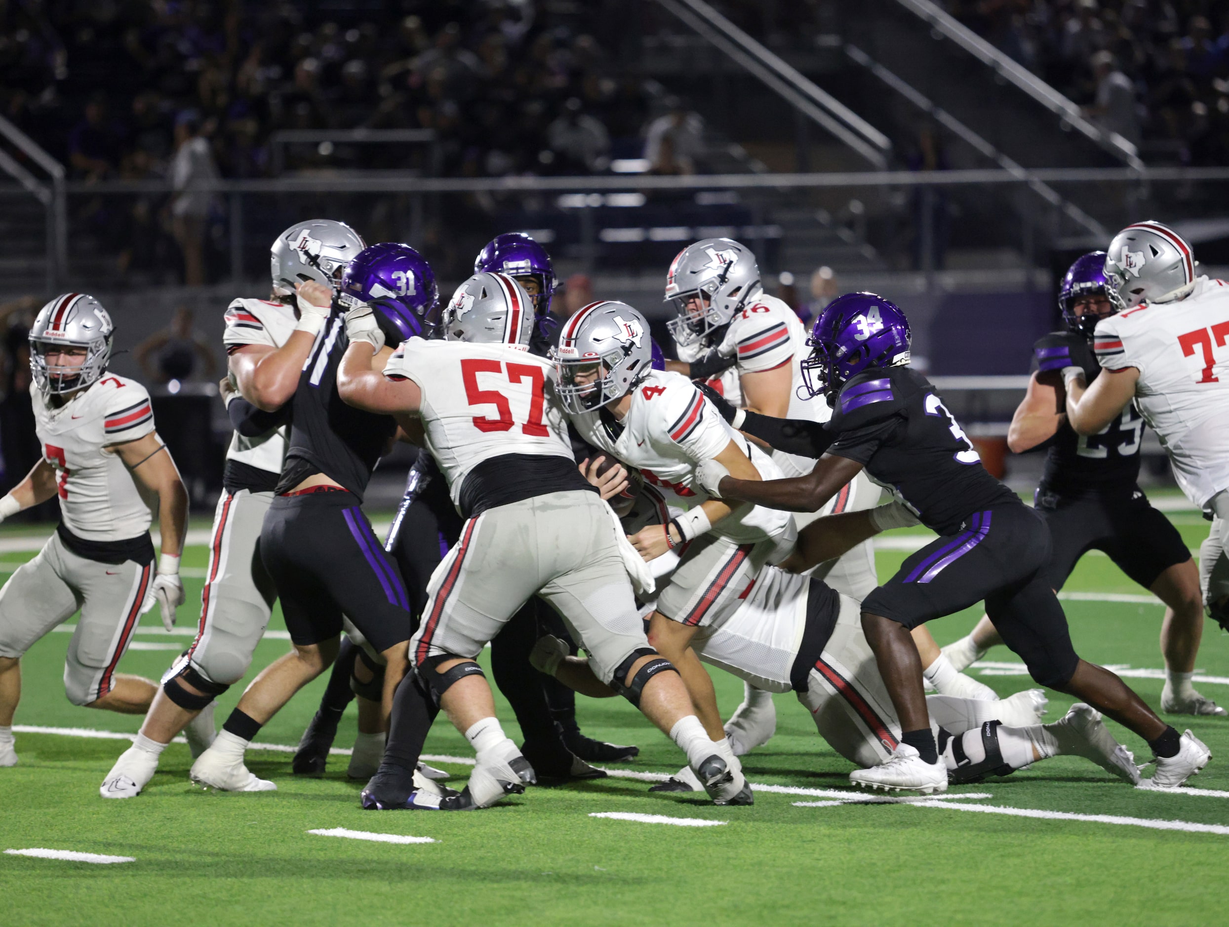 Lovejoy player #4 Jacob Janecek runs into a wall of players during the Lovejoy High School...