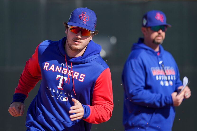 Outfielder Trevor Hauver participates in a base running drill during a Texas Rangers minor...