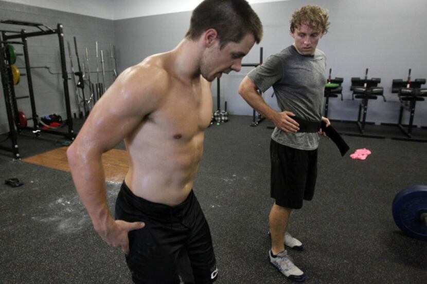 Trey Kubacak and Matt Anderson of the CrossFit Dallas Central team go over technique for the...