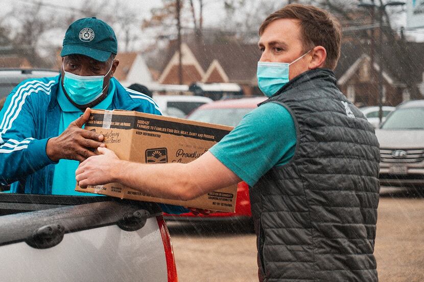 Socialwyze founder Cody Merrill and Texas Senator Royce West distribute food at Park South...