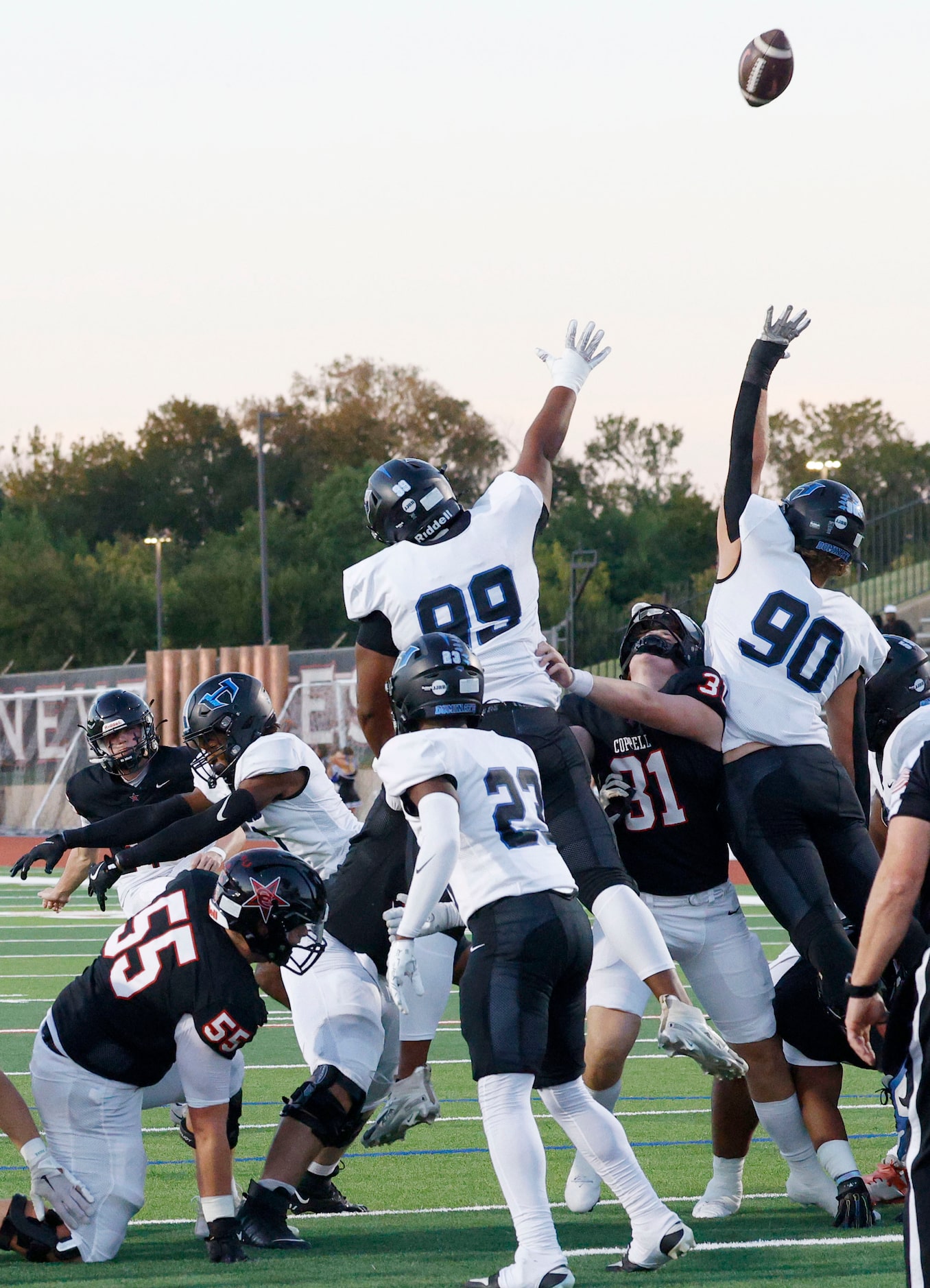 Coppell's kicker Bryson Patten (15), background left, scores a field goal against Hebron in...