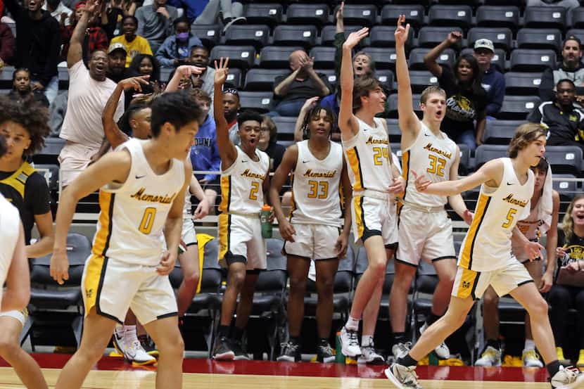 Memorial teammates and fans celebrate at the end of the Class 5A State Regional Basketball...