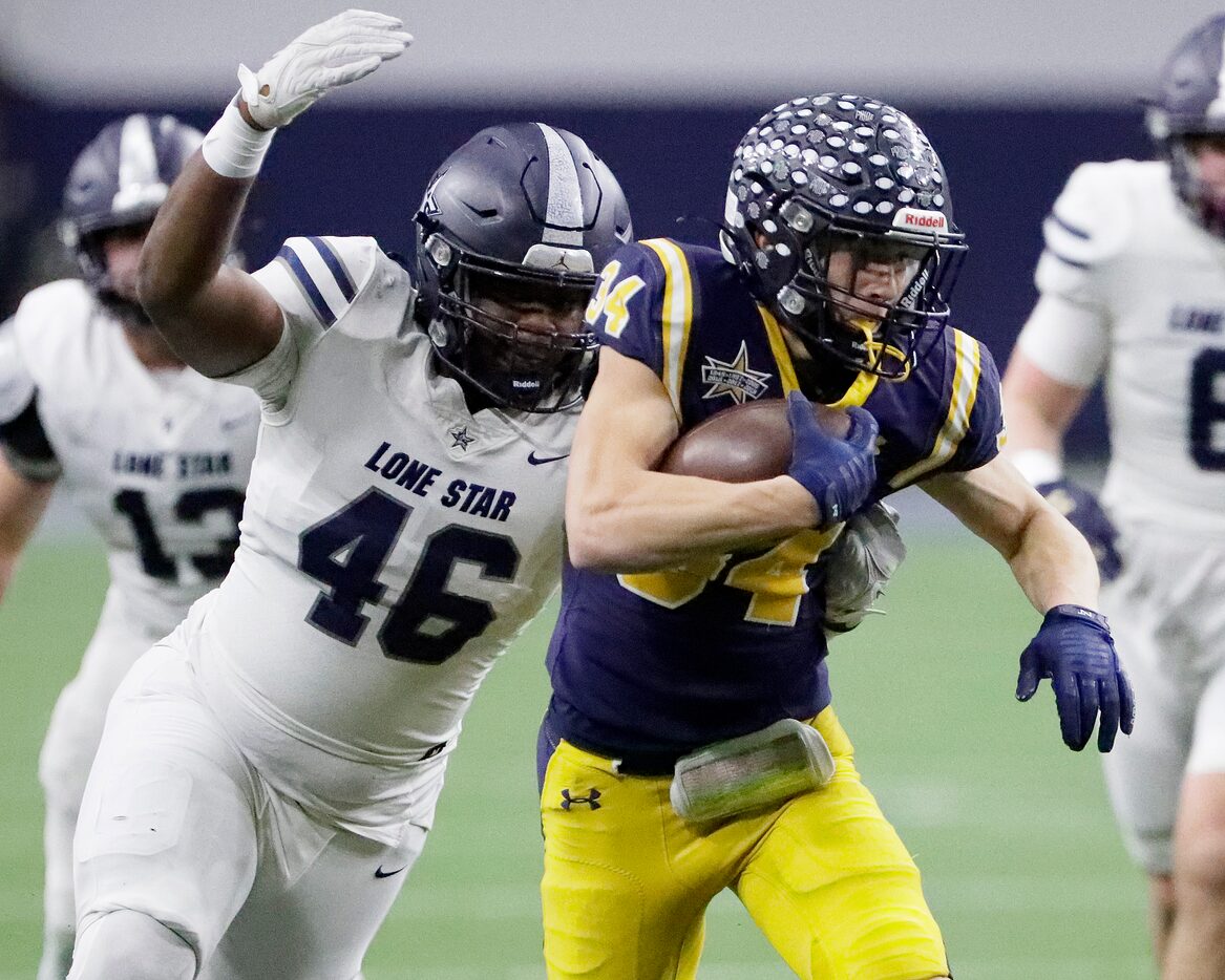 Highland Park High School running back Matthew White (34) is caught from behind by Lone Star...