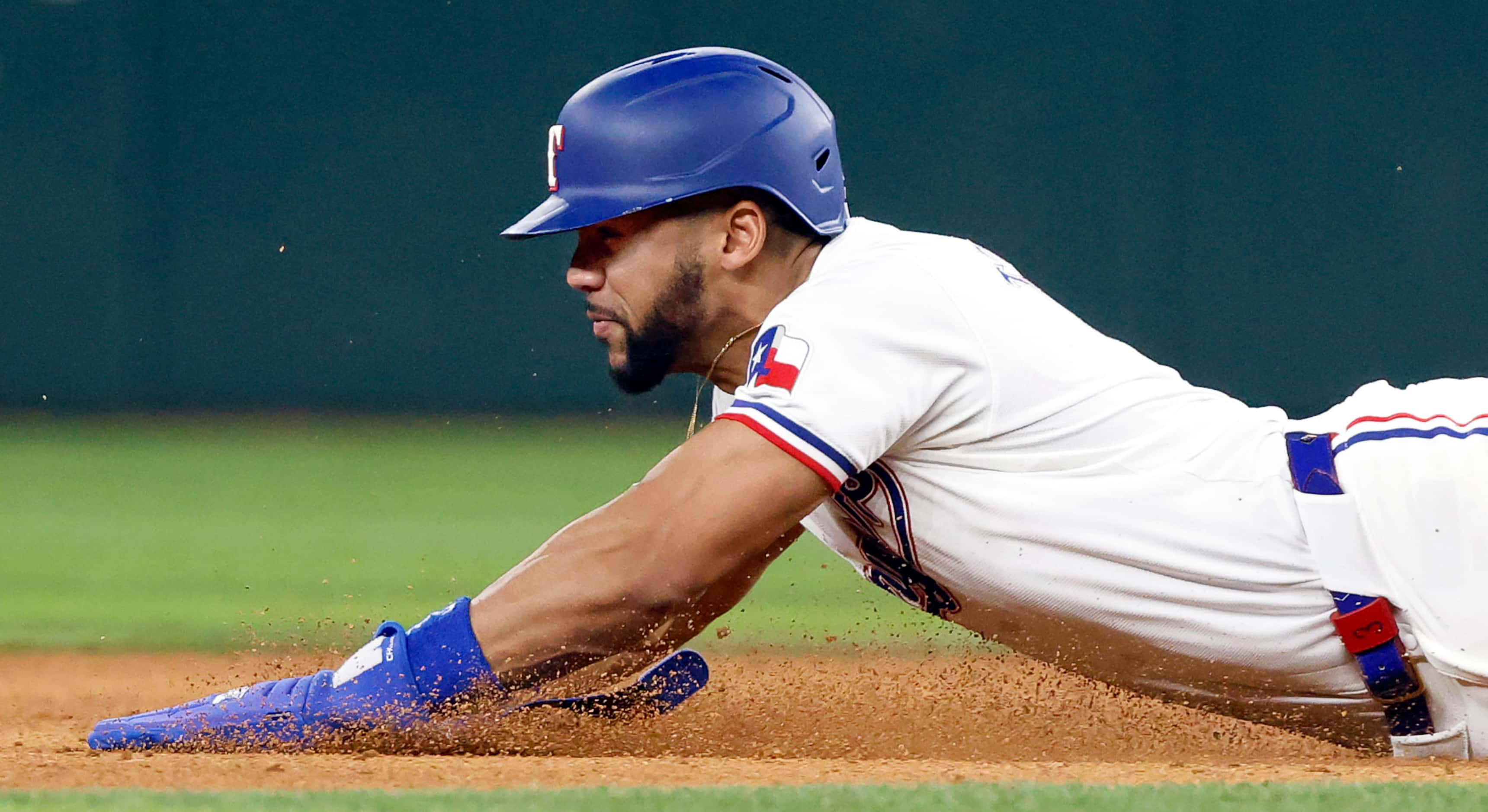 Texas Rangers outfielder Leody Taveras (3) slides safely into second on a stolen base...