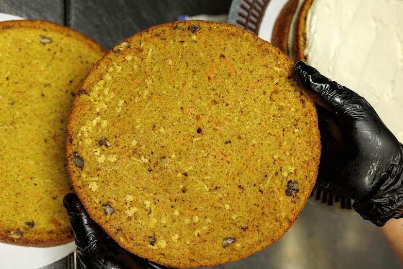 Truluck's pastry chef Paula Delgado shows a layer of carrot cake, which is made with pecans,...