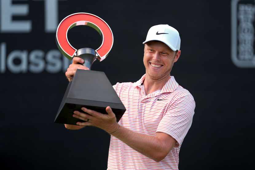 Cam Davis celebrates winning the Rocket Mortgage Classic golf tournament at Detroit Country...